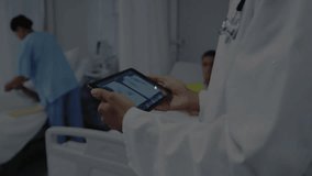 Senior doctor tapping tablet showing data overlays while nurse checking patient visualizing data. Medical, healthcare, technology, digital, connectivity, hospital, collaboration - Powered by Shutterstock - Get 15% off with code: PIKWIZARD15