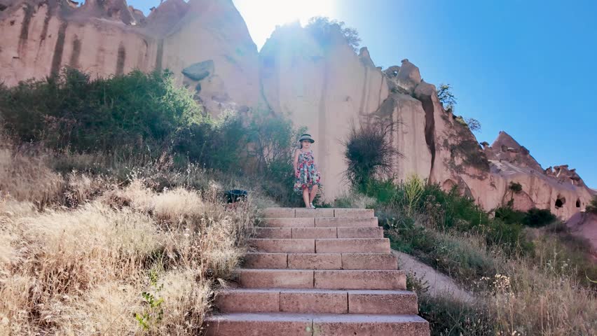 My 7-year-old daughter is exploring Cappadocia. A video of the Zelve Valley and Museum with a child model. Signs say: "There may be rocks falling" or "No entry."