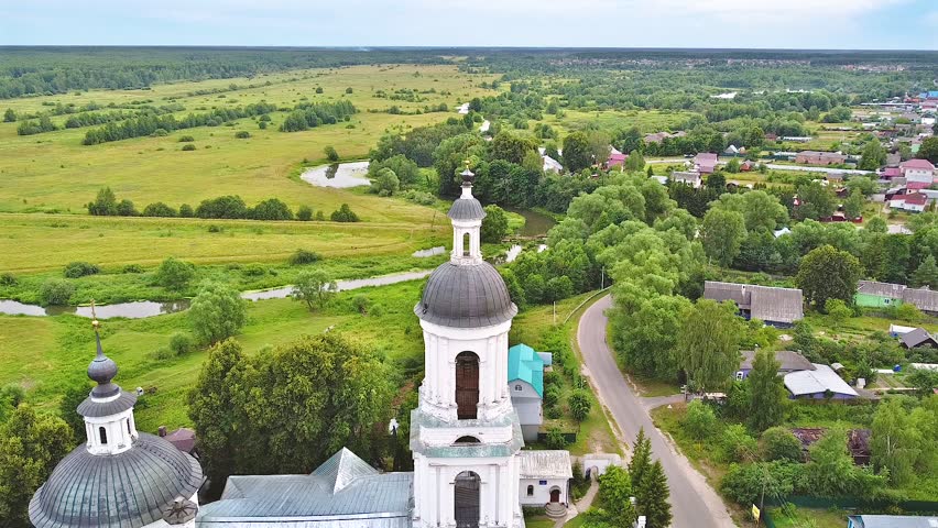 Landscape with orthodox church with fields under gloomy sky. Church of St. Nicholas - Filippovskoye village, Vladimir region, Russia
