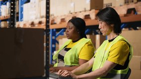 Team of two workers monitoring shipping route on tracking software, pointing at the pc monitor and updating the parcel shipment details. Typing logistics data on computer. Camera B. - Powered by Shutterstock - Get 15% off with code: PIKWIZARD15