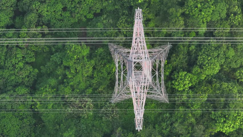 Aerial footage of High voltage line tower on mountain