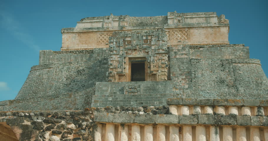 Front view of Pyramid of the Magician in Uxmal showing intricate Mayan carvings