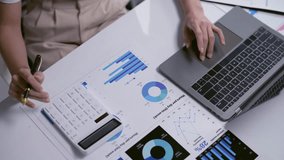 Accountant is analyzing financial data on a laptop and calculating numbers - Powered by Shutterstock - Get 15% off with code: PIKWIZARD15