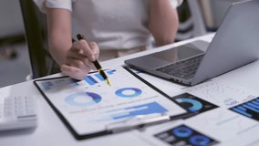 Businesswoman is examining financial data and reports, developing strategies for success - Powered by Shutterstock - Get 15% off with code: PIKWIZARD15