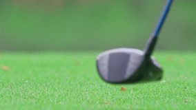 Close up of professional golfer swinging club on a scenic golf course. The shot captures the precise moment of striking the golf ball on the well maintained green fairway. - Powered by Shutterstock - Get 15% off with code: PIKWIZARD15