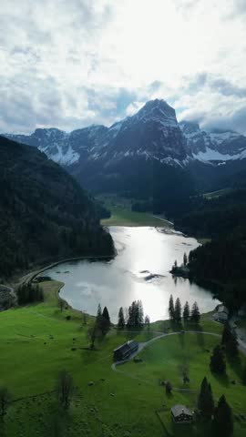 Switzerland nature aerial drone vertical Obersee lake Swiss Alps covered in snow