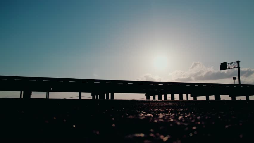 Silhouetted Semi Trailer Crossing Lake Pontchartrain Causeway at Sunrise