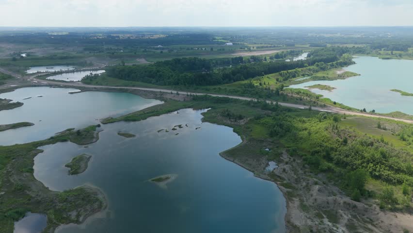 Aerial Flyover Of Quarry Lakes On A Gravel Pit Mining Worksite In Caledon, Ontario, Canada.