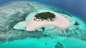 Patawan Island's white sand shores, lush palm canopy (Cocos nucifera), and vibrant coral reef systems off the southern coast of Palawan, Philippines, slow drone orbit - Powered by Shutterstock - Get 15% off with code: PIKWIZARD15