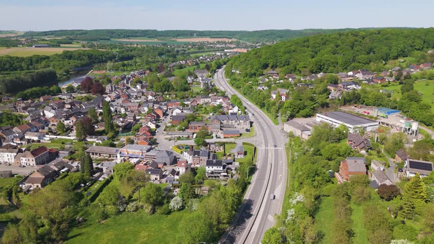 highway below traffic alongside sombre river right beautiful town floreffe abbey belgium highlighted scenic circling panning shot view side