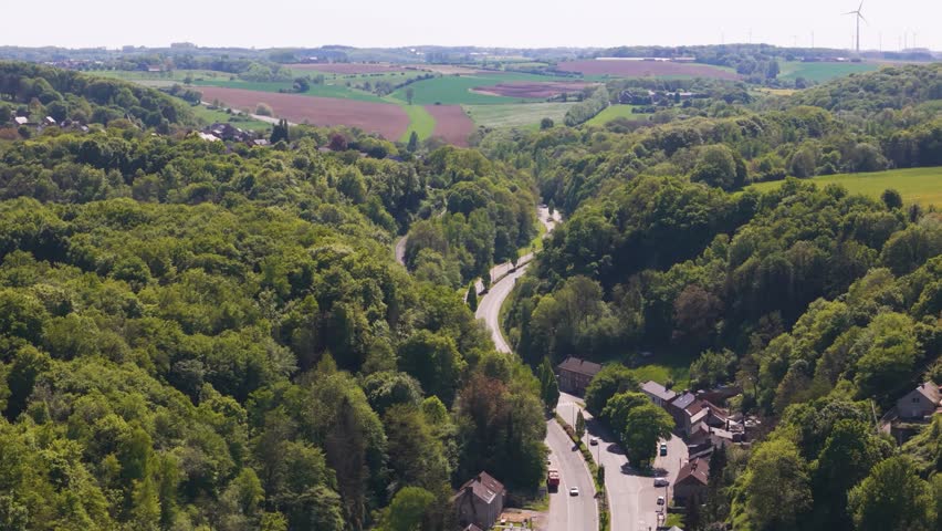 highway below traffic parked cars surrounded by green cover beautiful town floreffe abbey belgium right to left circling panning shot abbaye de