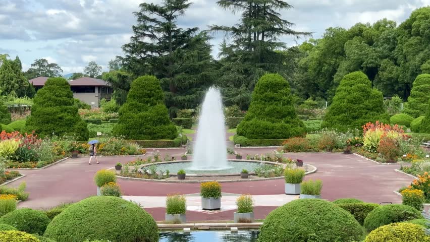 4K video of the serene atmosphere with view on the waters of the fountain outdoor at daytime during summer in the Kyoto Botanical Gardens surrounded by lush greenery in Japan.