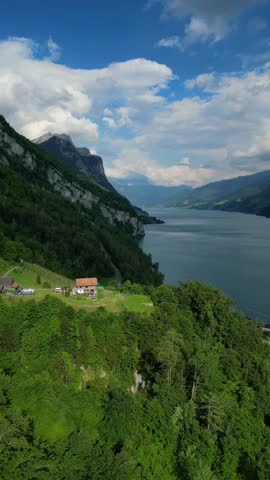 Switzerland alpine mountain lake resort in summer aerial drone vertical video Walensee lake