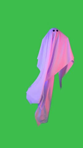 Halloween ghost made of white sheet and with black eyes floats in the air in pink and blue light isolated on green screen background with chromakey. Happy Halloween spooky concept. Vertical video.