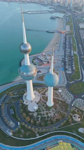 Vertical aerial of Kuwait Towers and coastline, ideal for travel, architecture, and editorial media.