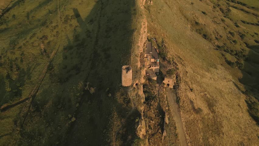 Aerial view Natlismtsemeli Monastery complex carved into cliffs, medieval Georgian Orthodox architecture in remote Kakheti hills. Part of David Gareja monastic complex. Azerbaijan Georgia border zone