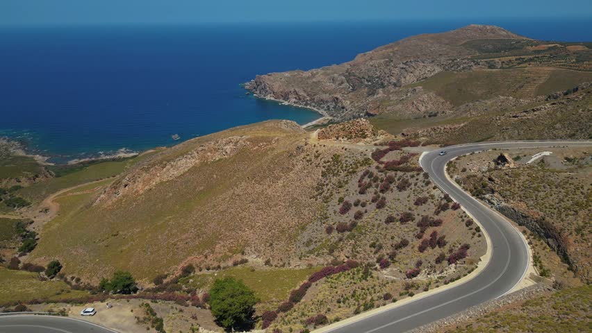 Winding Road On The Mountain Overlooking The Blue Sea In Chania, Crete, Greece. - aerial shot