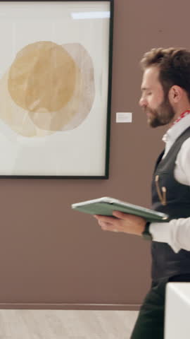 Curator, people and painting sale in art gallery for collection, design showcase and management. Creative exhibition, employee and tablet for catalog auction, team instructions and preservation