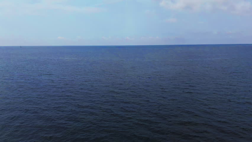 Clear Mediterranean sea with distant horizon in Liguria, Italy, peaceful view