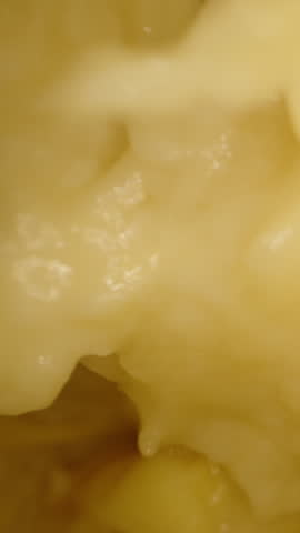 Dolly Slider Close Up of Spiky Durian Shell Partially Opened Showing Creamy Yellow Interior Texture with Natural Fibers Against Black Background, Tropical Detail Concept.