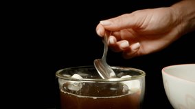 Hand Holding Spoon Scooping Marshmallows from Coffee Mug with Dolly Zoom Effect, Side Angle and Studio Lighting, Cozy Beverage Concept. - Powered by Shutterstock - Get 15% off with code: PIKWIZARD15