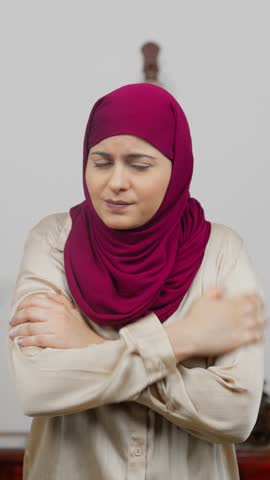 Vertical Video of Muslim Woman in Hijab Scarf Feeling Cold