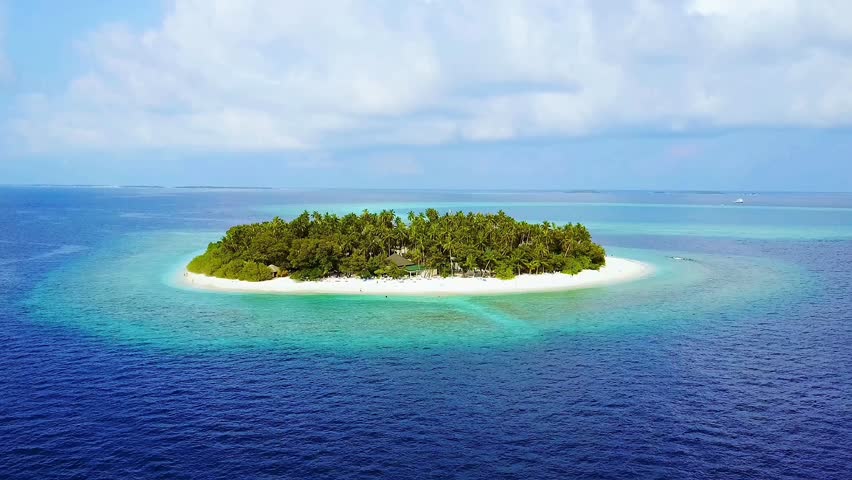 Stunning 4K aerial drone footage of a tropical island and clear turquoise water, under a sunny blue sky. Perfect for travel promos, island tourism, and nature documentaries.
