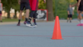 The footage captures an intense basketball practice, with players skillfully dribbling and engaging in exercises around orange cones, showcasing their agility and teamwork - Powered by Shutterstock - Get 15% off with code: PIKWIZARD15