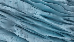 A close-up glacial footage capturing the fine textures, crevices, and shimmering blue tones of Engabreen ancient ice in motionless stillness - Powered by Shutterstock - Get 15% off with code: PIKWIZARD15