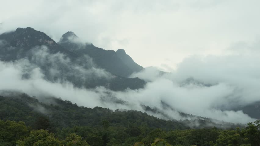 Doi Luang Chiang Dao mountain in morning mist with clouds and lush forest