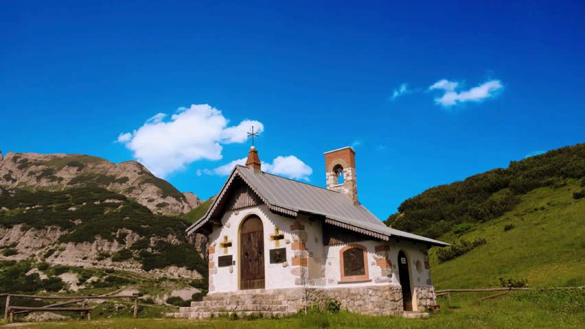 Lovely small old Church in Bettmeralp Alps mountain village, Switzerland. Summer cloudy view.The beautiful Catholic Church in the valley of Theth National Park, Albania. albanian alps