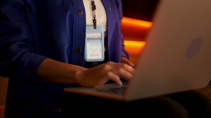 Female IT specialist typing on laptop, providing freelance tech support service