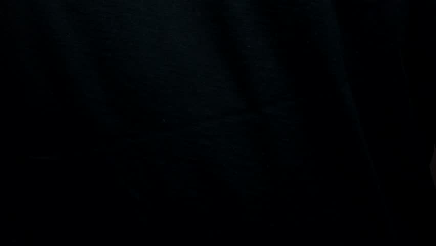 A man's hand on a black background snaps his fingers.
Clicking fingers on a black background close-up.
Fingers clinking