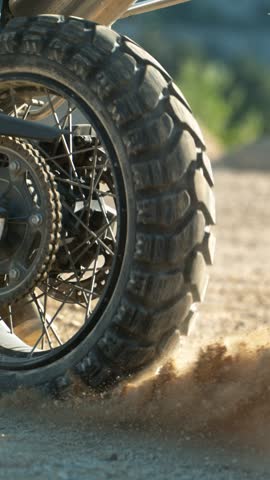 Super slow motion of flying rocks and dust from the wheel of a motocross bike at the start of the race