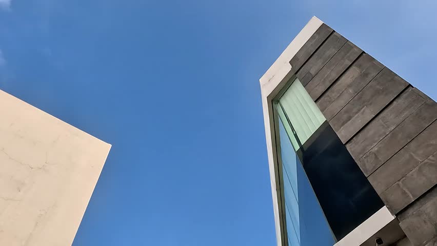 Modern building with blue sky background. Background for project or quotes.