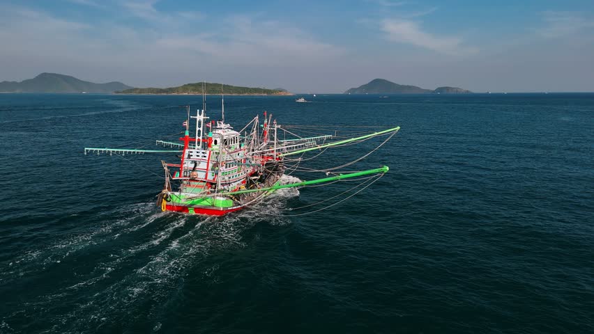 Traditional fishing boat sailing near Phuket, Thailand, showcasing local fishing industry and marine activity