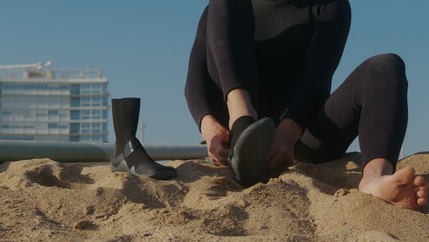 Surfer man walking to the beach at sunset preparing for surfing training and search for waves in Barcelona, spain, water, ocean exercise in sea with board, athletic male holiday or travel in vacation.