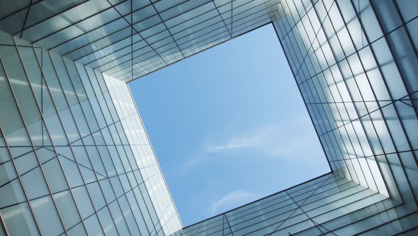 A Beautiful Modern Architectural Perspective Viewed from Below Against a Clear Blue Sky