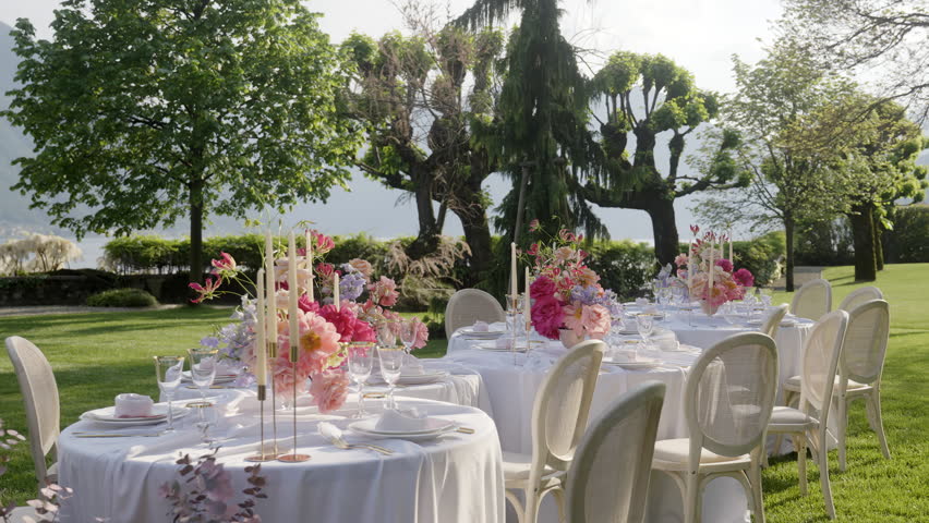 A Beautifully Elegant Outdoor Dining Setup Complete with Stunning Floral Arrangements. Action