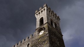Medieval stone tower clock standing tall against a stormy sky. Action - Powered by Shutterstock - Get 15% off with code: PIKWIZARD15