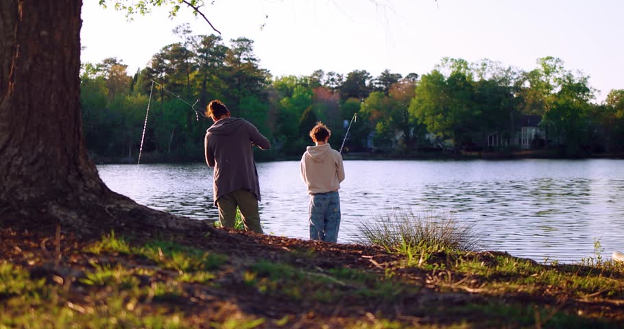 Dad and Son Enjoy Quiet Fishing Time by the Lake – Summer Evening Stillness and Family Bond