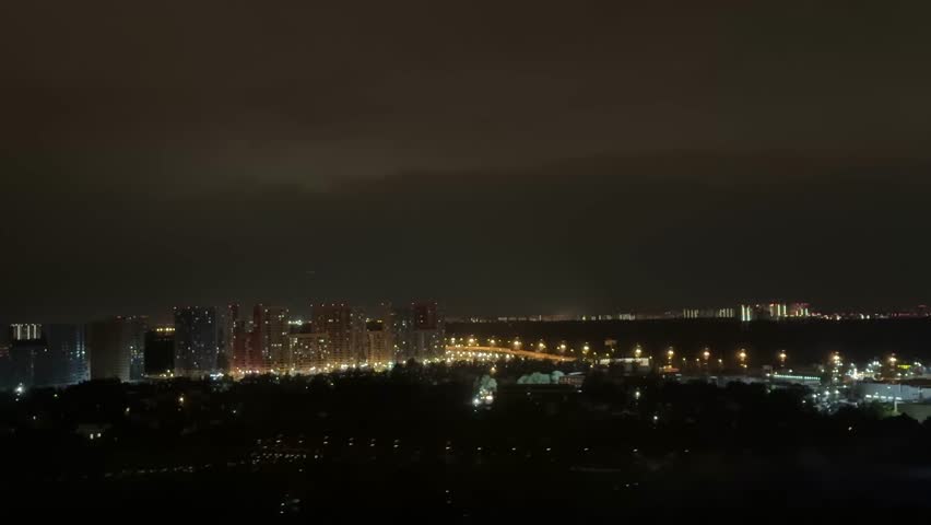Stormy night. Lightning strikes near  house. Night sky dark, full of powerful lightning.  Rural setting. Nature scene. Home safety. Weather emergency. Thunderstorm danger.time lapse clouds over city