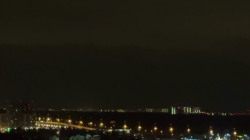 Stormy night. Lightning strikes near  house. Night sky dark, full of powerful lightning.  Rural setting. Nature scene. Home safety. Weather emergency. Thunderstorm danger.time lapse clouds over city