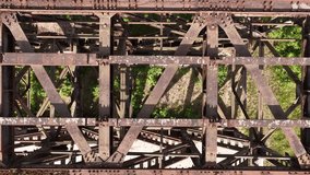Aerial View of Rusted Steel Bridge Structure with Overgrown Vegetation - Powered by Shutterstock - Get 15% off with code: PIKWIZARD15