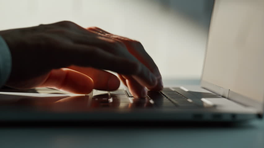 Businessman hands writing email on laptop at corporate office space closeup. Unrecognizable man typing on keyboard browsing internet website. Male freelancer working online on apartment desk indoors 