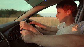 Driver dad child son driving car. Happy family, childhood. Dad teaches his little son to turn steering wheel while sitting in driver seat of auto. Father travels with children by car. Driving car kid - Powered by Shutterstock - Get 15% off with code: PIKWIZARD15
