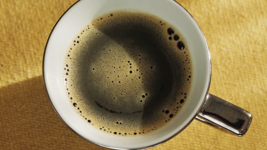 Cup of invigorating freshly brewed coffee on the table. Close-up of chicory drink. High quality 4k footage