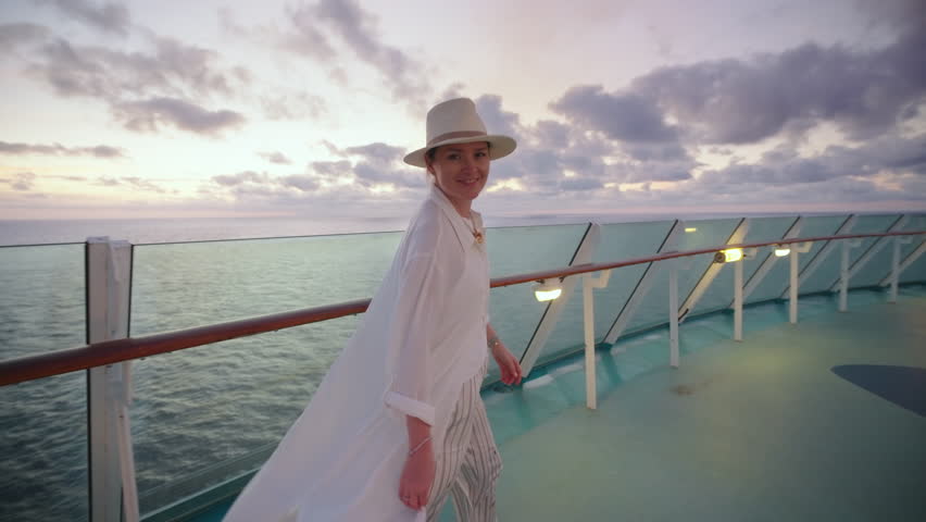 Imagine strolling on a luxurious cruise ship deck at sunset, enjoying stunning ocean views and fluffy cloudsan ideal moment for relaxation, where natures beauty and warm breezes create tranquility