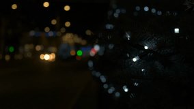 Christmas tree installed on main street. A view of installed Christmas tree with garlands by the city street during night time. A concept of Christmas holidays time. - Powered by Shutterstock - Get 15% off with code: PIKWIZARD15