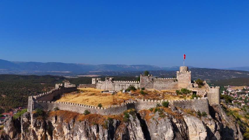 Aerial view of historic Boyabat Castle on a rocky hilltop in Sinop, Turkey. Captured by drone in clear weather, showcasing ancient walls, towers, and scenic mountain landscape. Turkiye 4k ultrahd 